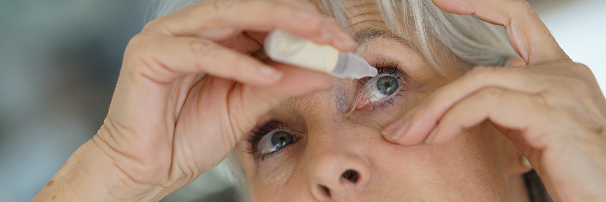 Woman Using Eye Drops to fight dry eye 