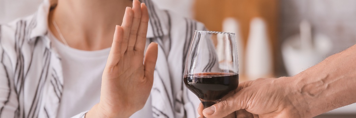 Hand turning away wine