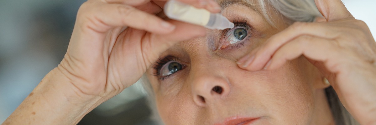 a woman with dry eyes using eye drops