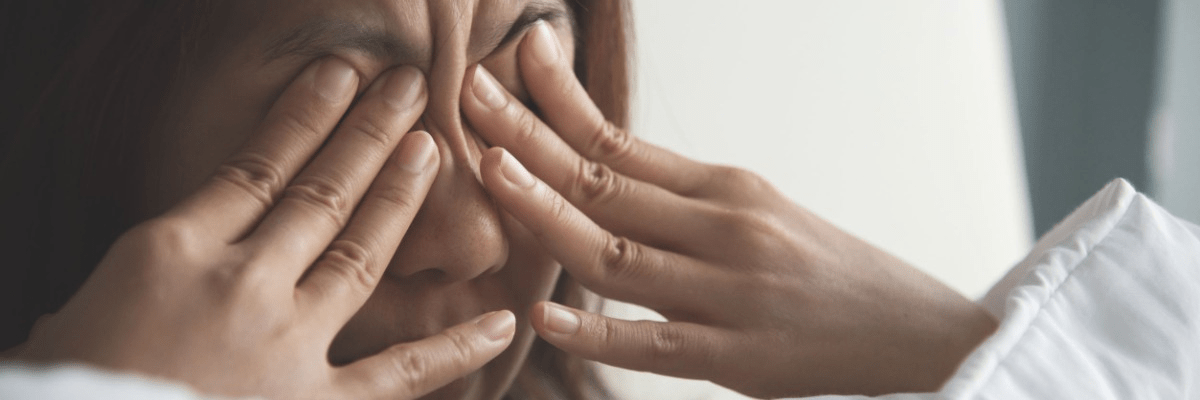 Close up shot of woman rubbing eyes with hands